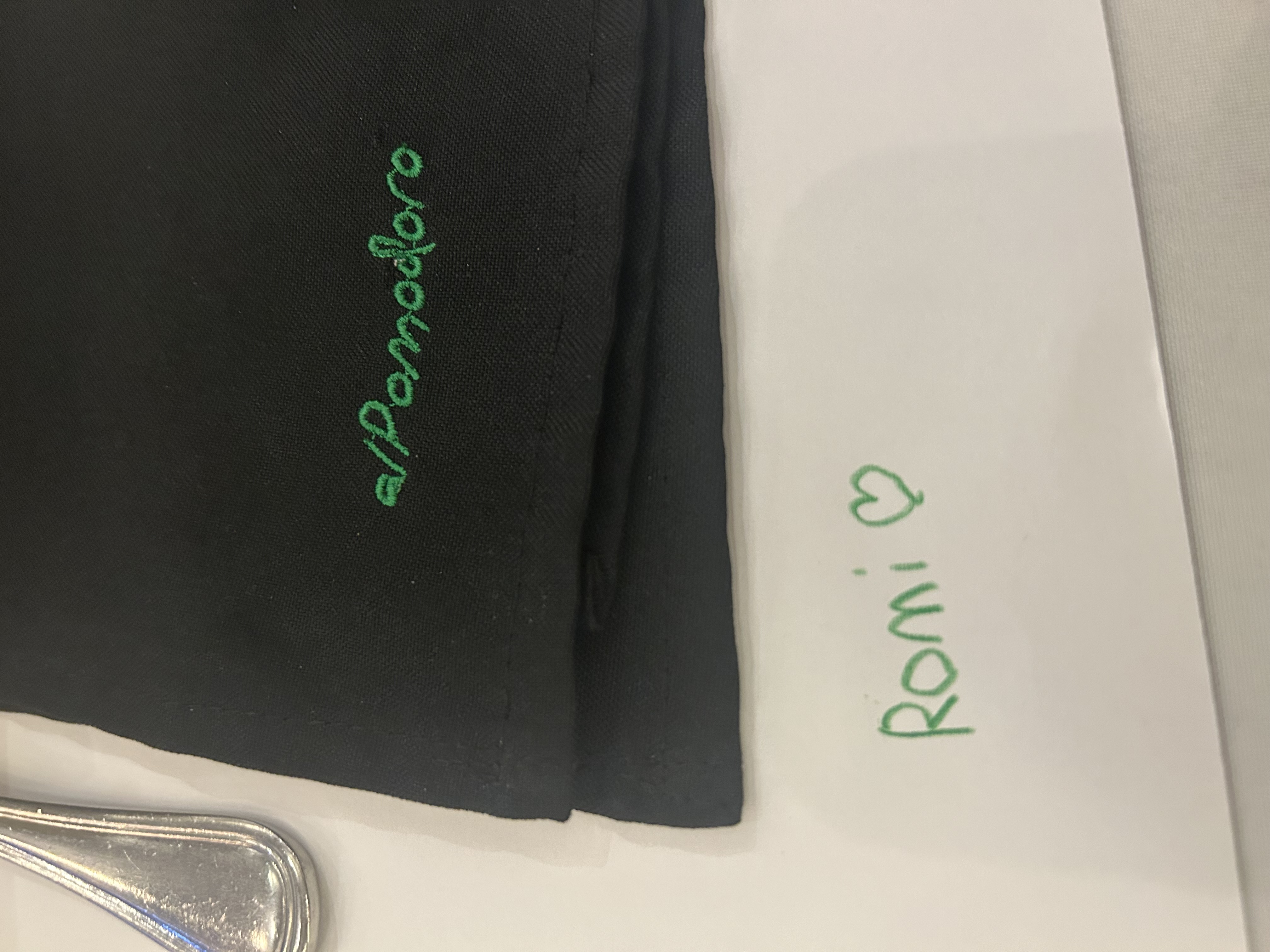 A restaurant napkin embroidered al Pomodoro with Romi and a heart written below